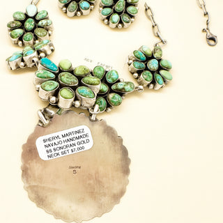 Jewelry set with green stones and silver accents on a white background, featuring a label indicating Sheryl Martinez Navajo handcrafted gold neck set.