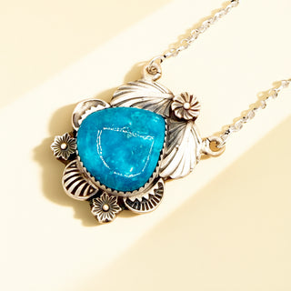 Necklace with a blue pendant on a beige background