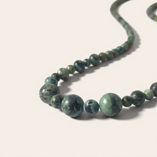 Necklace with green beads on a light background