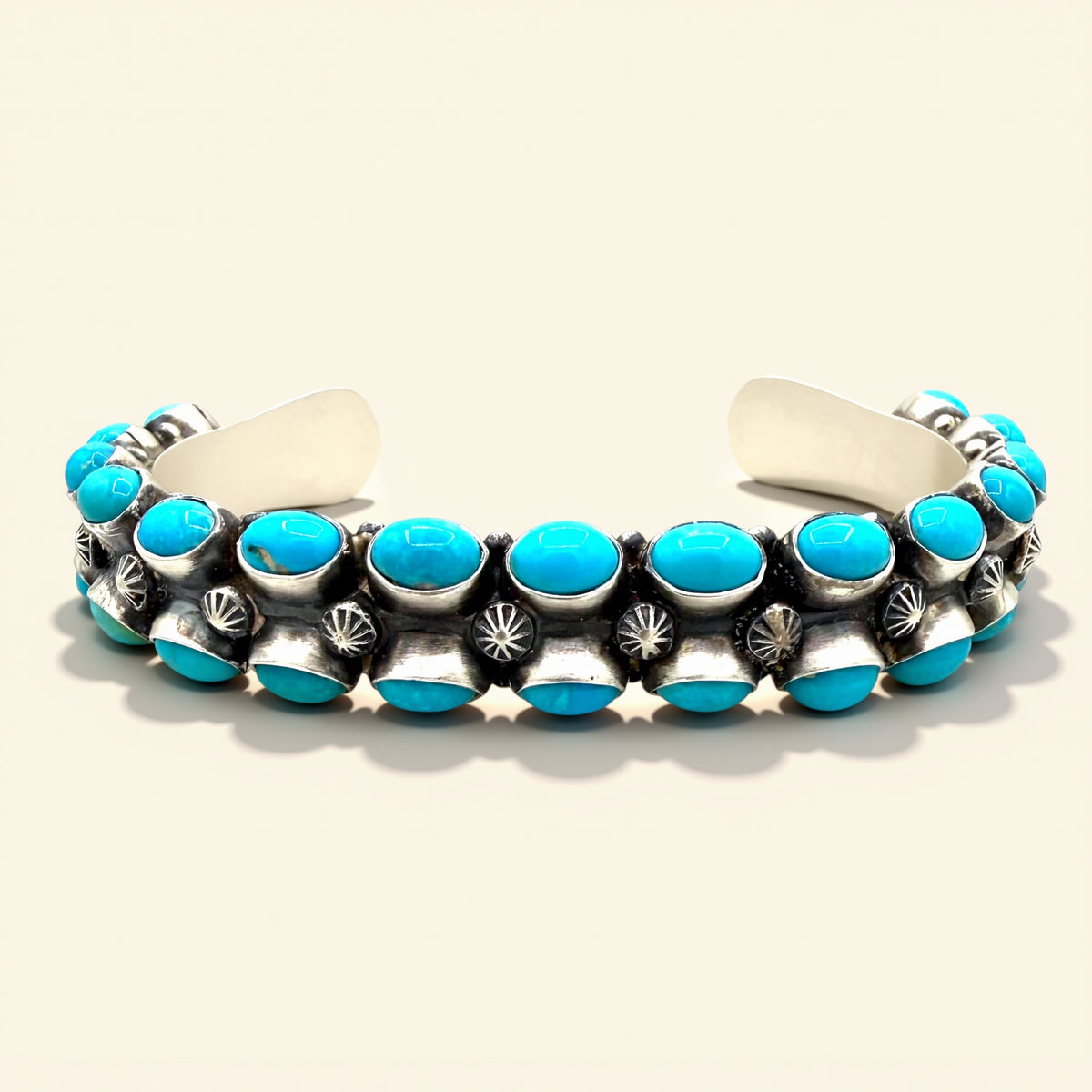 Turquoise and silver bracelet on a white background