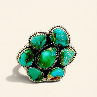 Turquoise ring with silver setting on a beige background