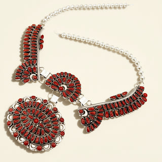 Necklace with red gemstones on a beige background
