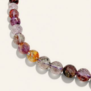 purple beaded jewelry on a beige background