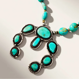 turquoise beaded necklace on a beige background