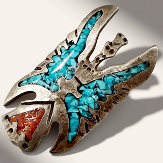 silver jewelry with turquoise and red stone on a beige background
