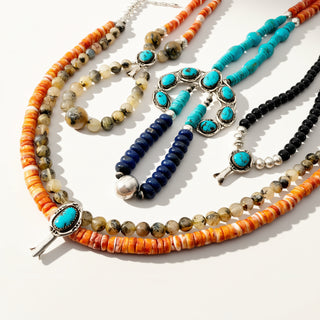 Set of colorful beaded necklaces on a white background