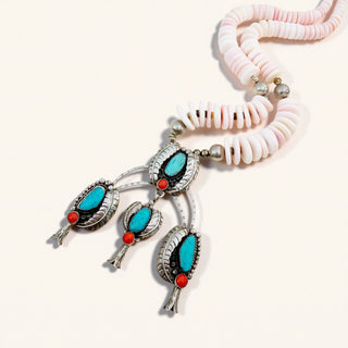 Necklace with shell beads and turquoise stone pendants on a white background