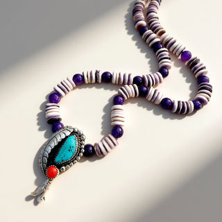 Necklace with beads and a turquoise stone on a light background
