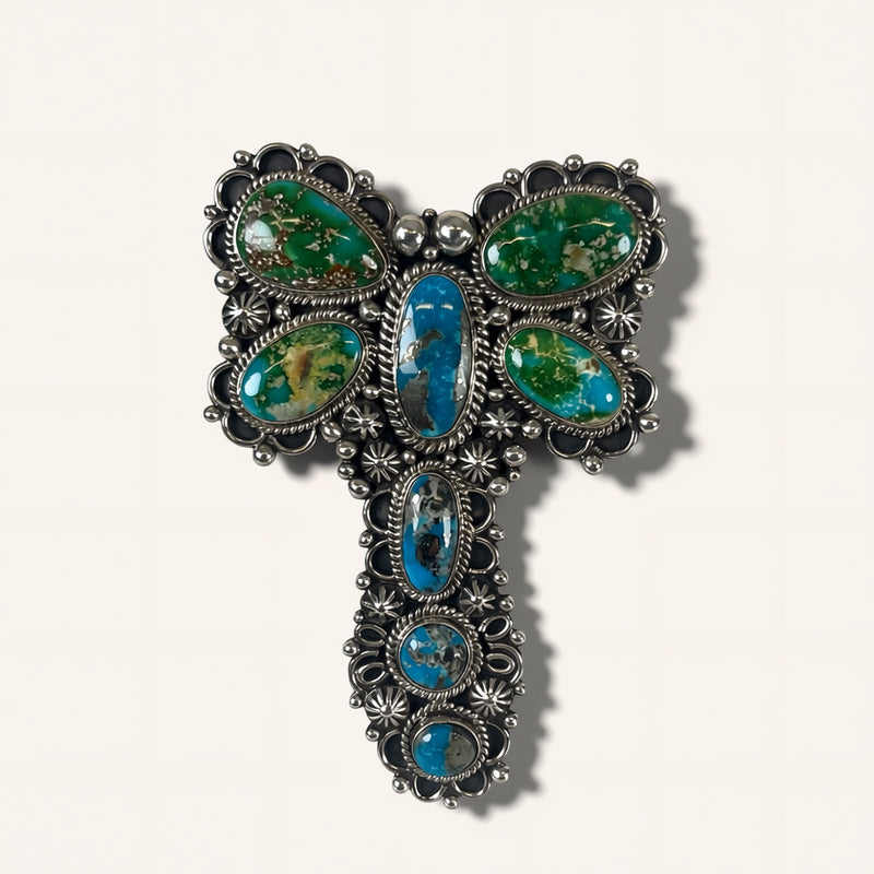 Silver brooch with turquoise stones on a white background