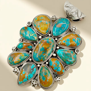 Turquoise and silver jewelry piece on a beige background