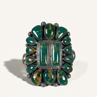 Green stone ring with silver band on a white background