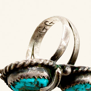 Silver ring with turquoise stones on a white background