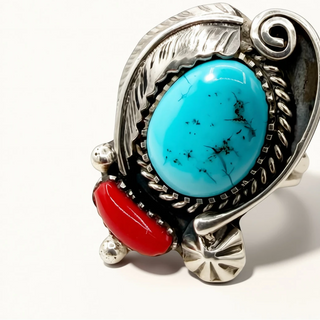 Silver ring with turquoise and red stone on a white background