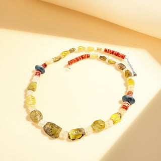 Colorful necklace with various stones on a beige background