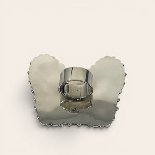 Silver napkin ring on a scalloped-edge silver holder with 'ZD' logo on a white background